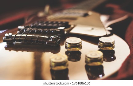 Close-up of an electric guitar laying inside a guitar case. Retro style photo.