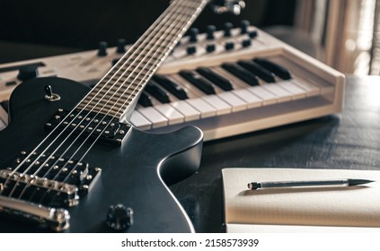 Close-up, electric guitar and piano, the concept of musical creativity, modern musical instruments. - Shutterstock ID 2158573939