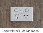 Close-Up of Electrical Power Outlet on Wood Wall