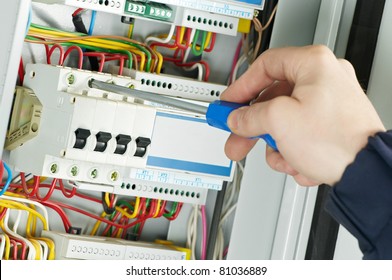 Close-up Of Electrician Work On A Industrial Panel Mounting And Assembling New Wiring