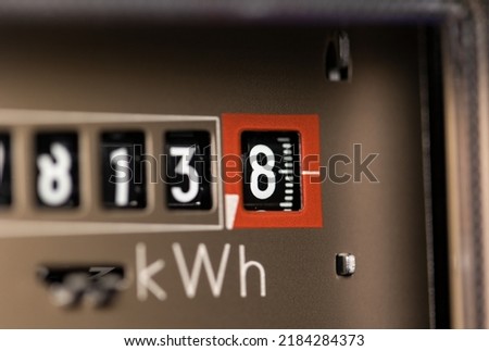 Close-up electricity meter. Analog gauge for households. Measuring the electricity consumed in kWh (kilowatt hours)