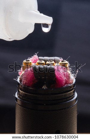 Closeup of an electronic cigarette with a drop of liquid
