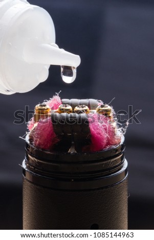 Closeup of an electronic cigarette with a drop of liquid