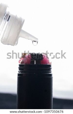 Closeup of an electronic cigarette with a drop of liquid