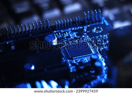closeup Electronic circuit board chips, computer hardware with dark blue lighting