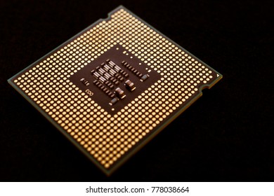 Closeup of an electronic circuit board with a processor. On a black background.