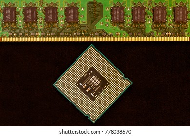 Closeup of an electronic circuit board with a processor. On a black background.