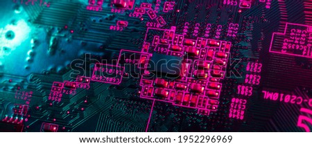 Close-up of electronic circuit computer microchips in neon colors