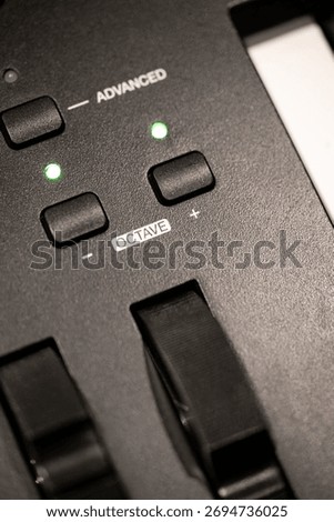 Close-up of an Electronic Keyboard Control Panel Featuring Octave Adjustment and Advanced Settings with Illuminated Indicators