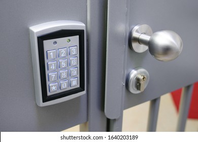 Closeup Of Electronic Lock With Keypad  And Steel Bobble Handle On Metal Bar Security Door