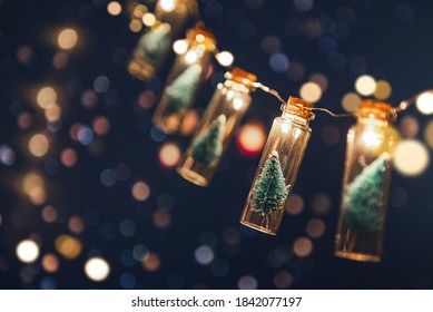 Close-up, Elegant Christmas tree in glass jar with bokeh lights background, copy space. Christmas and new year concept. - Shutterstock ID 1842077197