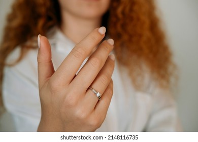 Close-up of an elegant engagement diamond ring on beautiful woman's finger. love and wedding concept. Like the split tone Instragram process.
