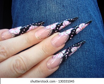 Closeup Of Elegant Stiletto Nails With Russian Motif Free Hand Drawn Flowers And Dots