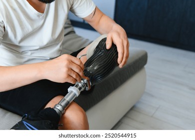 Close-up elevated view of a man adjusting the screws on an artificial prosthetic leg. - Powered by Shutterstock