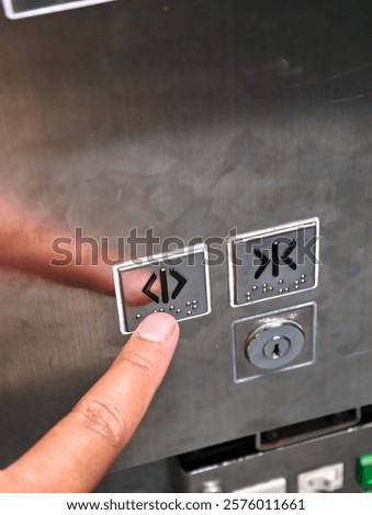A Close-up of an Elevator Button with Braille