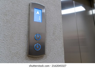 Close-up Of The Elevator Call Button Up And Down With Braille. Arrow Shows The Lift Going Up