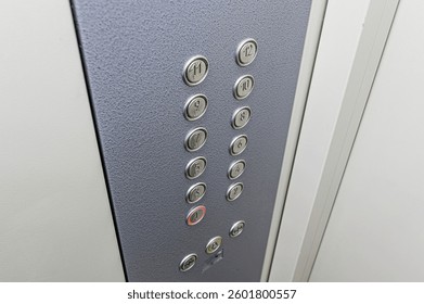 Close-up of an elevator control panel with floor buttons numbered 1-12.