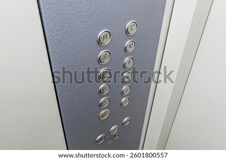 Close-up of an elevator control panel with floor buttons numbered 1-12.