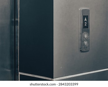Close-Up of Elevator Floor Button Panel with Up-Down Arrows and Digital Display