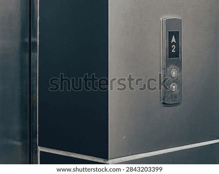 Close-Up of Elevator Floor Button Panel with Up-Down Arrows and Digital Display