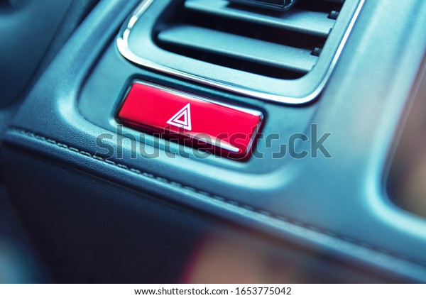 Close-up to emergency\
light button in car
