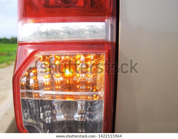 Closeup of emergency lights for pickup trucks Send\
the emergency signal of the golden pick-up truck parked on the\
road. With copy space