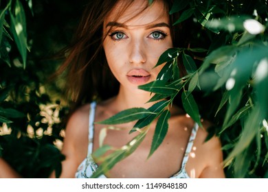 Closeup Emotional Artistic Portrait Of Amazing Fabulous Beautiful Young Cheerful Model Girl With Big Natural Lips And Blue Passionate Eyes Looking At Camera Outdoor At Nature.  Cute Lovely Teen Face