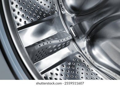 Close-up of a empty drum inside washing machine in a home. Preparing to wash dirty clothes.  Selective focus.