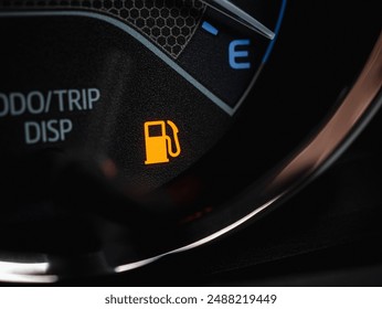 Close-up of empty fuel warning light in car dashboard. Fuel pump icon. gasoline gauge dash board in car with digital warning sign of run out of fuel turn on. Low level of fuel show on speedometer - Powered by Shutterstock