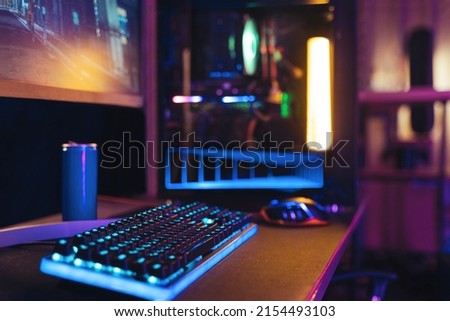 Close-up of empty gaming streaming studio equipped during first person shooter online competition. Professional setup with powerful computer, keyboard, monitor and mouse ready for online championship 