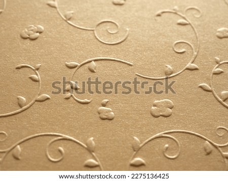 Close-up, Empty gold glittering small floral paper for your image, text, art, design, banner, wallpaper, and backdrop. Blank flower embossing paper gold colour. 
