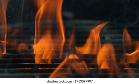 Closeup of empty grill with fire, isolated on black background