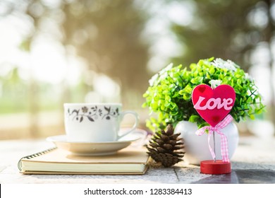 Close-up of empty notebook and cup of coffee on Marble floor background. Love concept with heart desktop,Valentine's Day.