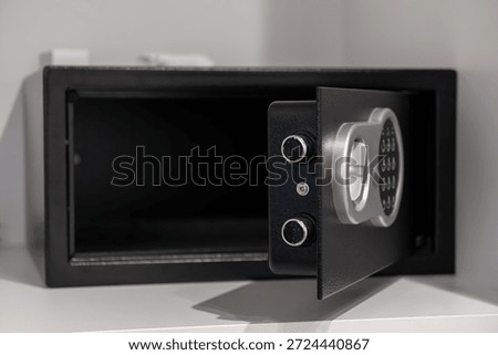 Close-up of an empty open electronic safe featuring a modern digital keypad, ensuring secure storage for valuables in hotel rooms or residential settings