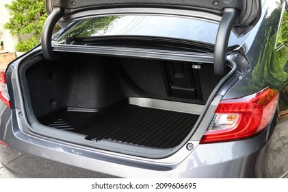 Closeup of empty rear cabin of gray sedan car. Preparing for luggage and suitcase loading.