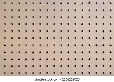 Closeup Of An Empty Section Of A Pegboard Wall In A Garage