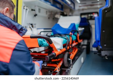 Close-up of empty stretcher inside ambulance vehicle.