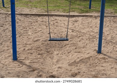 Closeup of empty swing seat and chains in modern playground in Düsseldorf, Germany - Powered by Shutterstock - Get 15% off with code: PIKWIZARD15