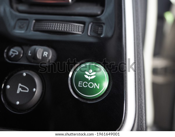 Closeup energy save mode button of eco car shiny\
and clean