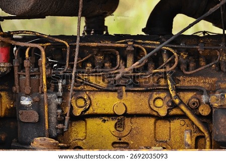 A close-up of the engine on an old crawler tractor