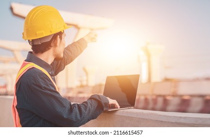 Closeup Engineer Hard Hat Using Computer Notebook For Work In Construction Site