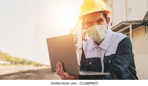 Closeup Engineer Hard Hat Using Computer Notebook For Work In Construction Site