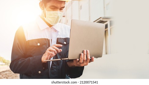 Closeup Engineer Hard Hat Using Computer Notebook For Work In Construction Site