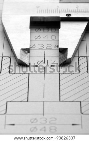 Close-up of engineering drawing and caliper