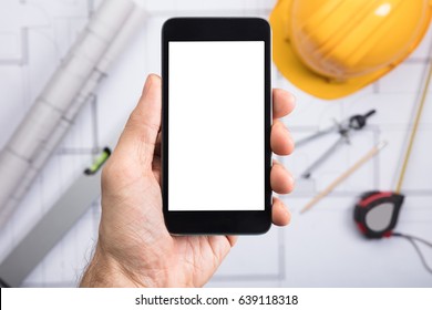Close-up Of A Engineer's Hand Holding Cell Phone With Blank Screen