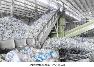 closeup escalator with a pile of plastic bottles at the factory for processing and recycling. PET recycling plant