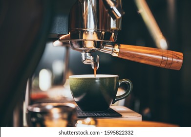 Close-up of espresso pouring from coffee machine. Professional coffee brewing - Powered by Shutterstock