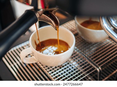 Close-up of espresso pouring from the coffee machine into a coffee cup. Professional coffee brewing - Powered by Shutterstock