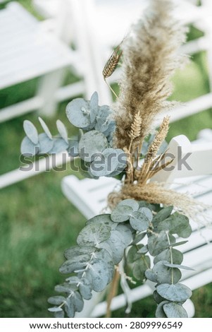 A close-up of eucalyptus and pampas grass placed for a wedding ceremony.