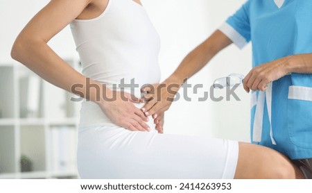 Close-up of examination by woman gynecologist, doctor touch belly, clinic appointment. Gynecology consultation in clinic, pregnancy checkup. Health concept
